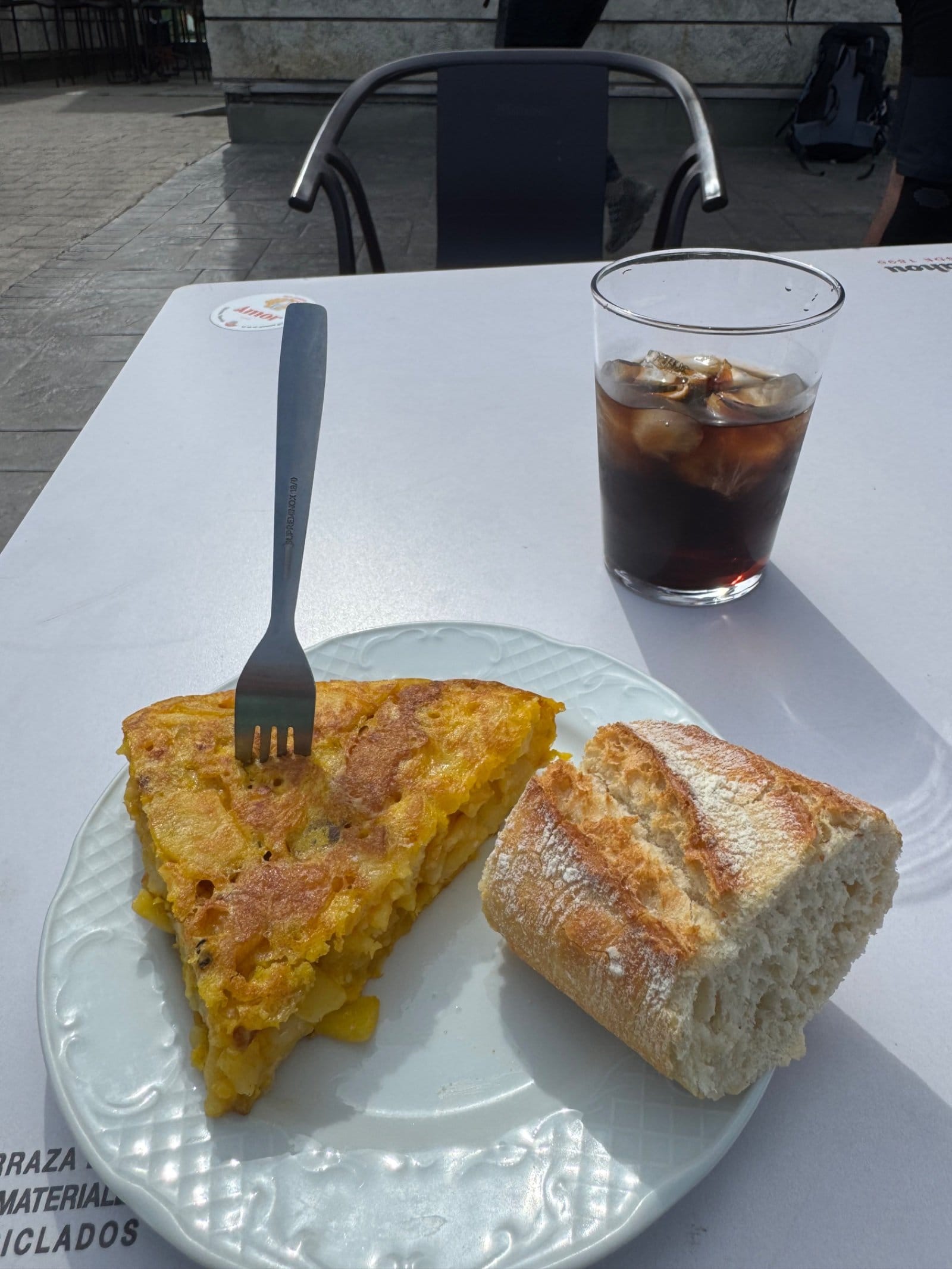 Tortilla española and Coke on outdoor table