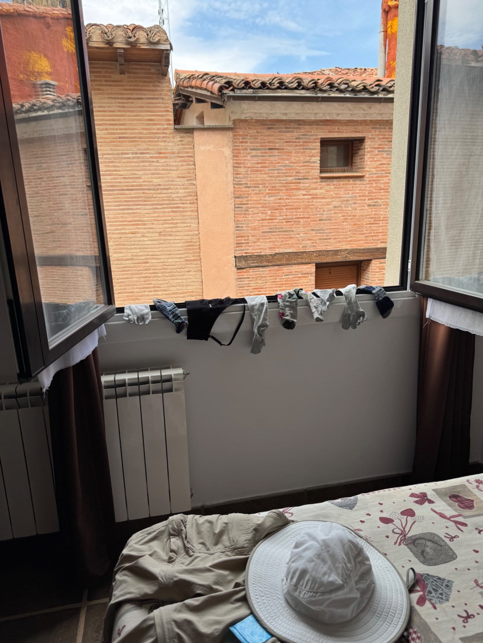 Laundry drying on bedroom window balcony