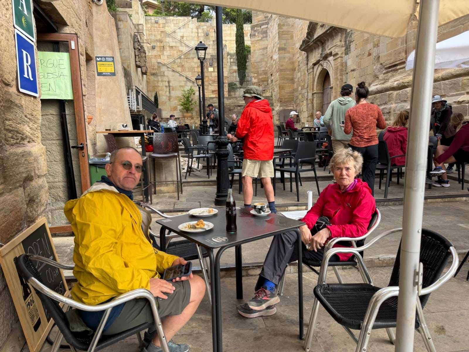 Pilgrims at bar terrace in Nájera after rain