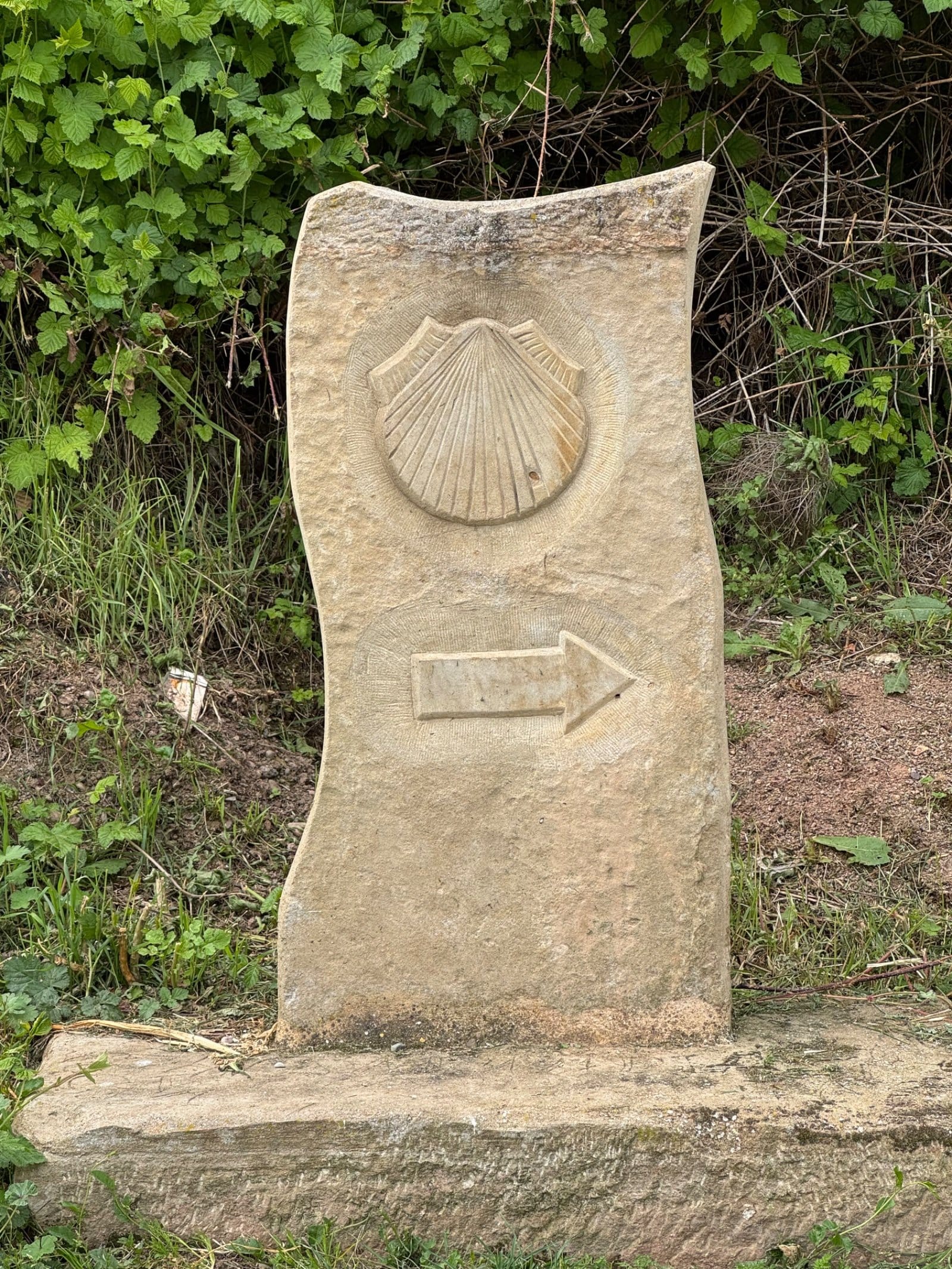 Stone Camino waymarker with scallop shell