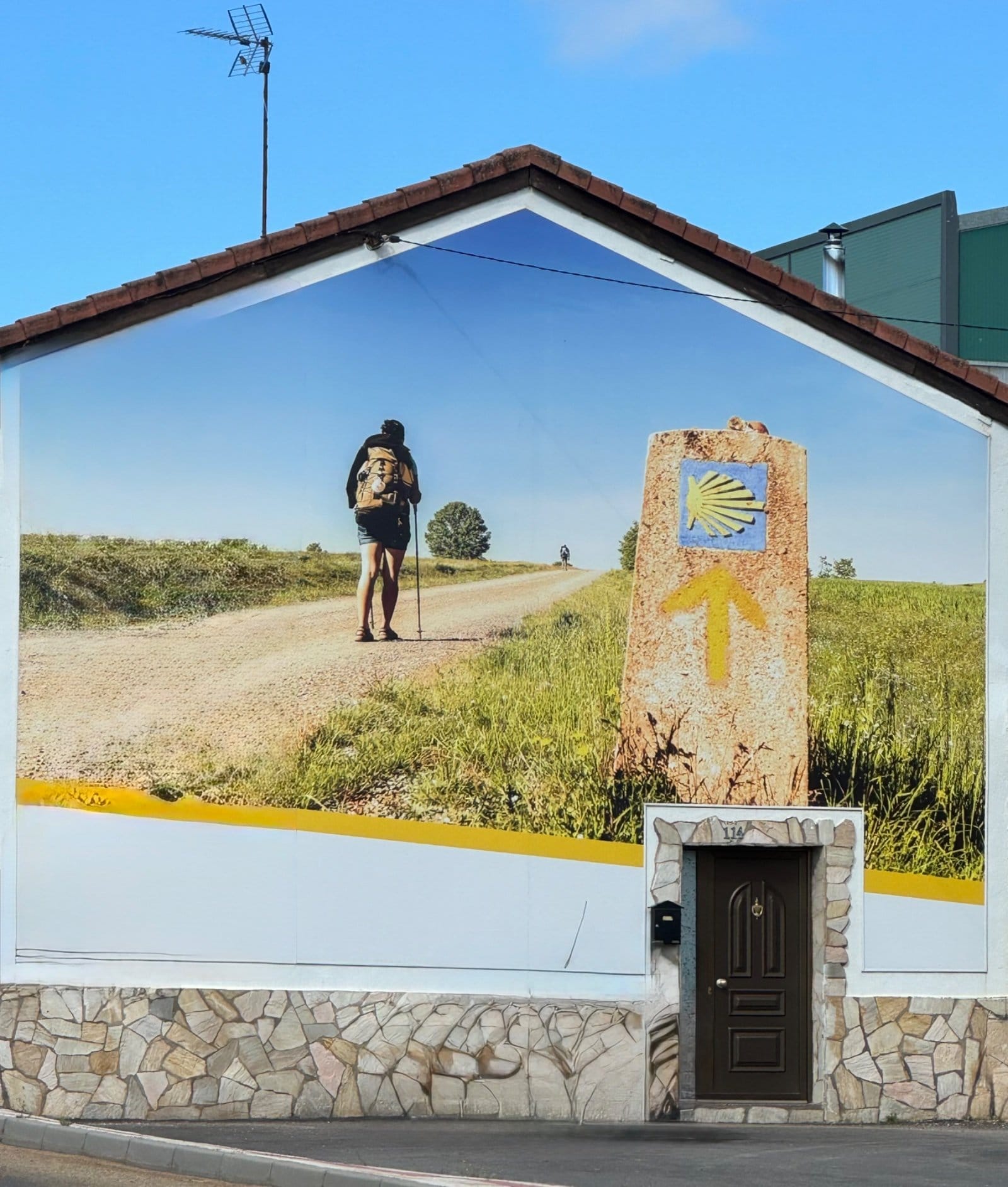 Camino pilgrim mural with waymarker