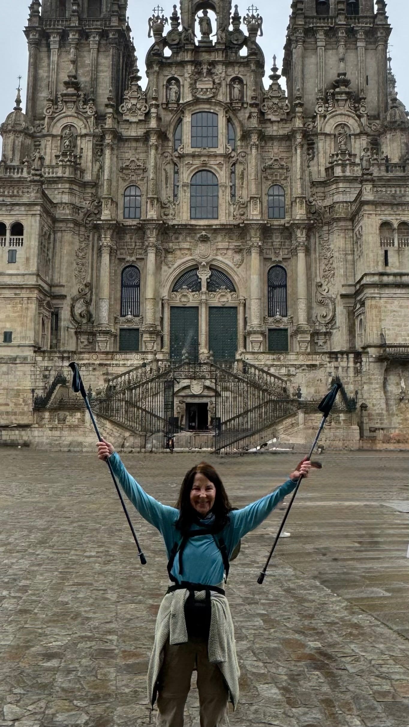 Victorious arrival at Santiago Cathedral with hiking poles