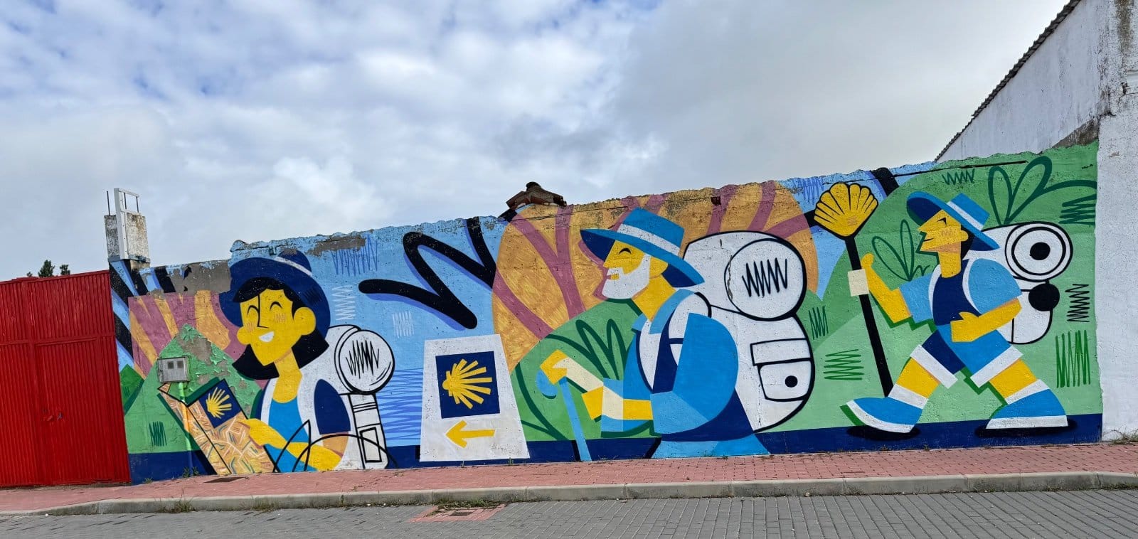 Camino pilgrims mural with shells and yellow arrows