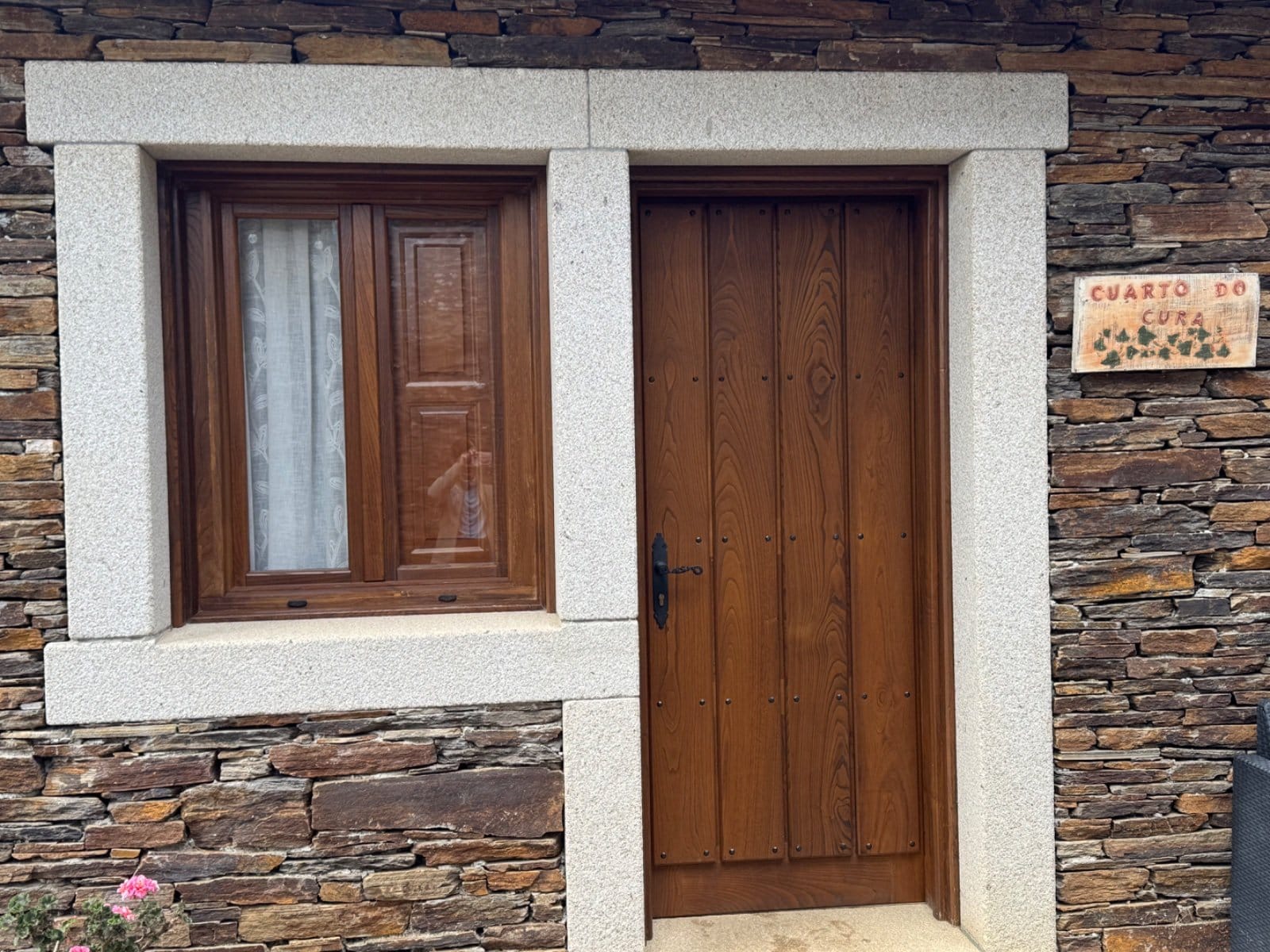 Stone house with traditional wooden door in Galician hamlet