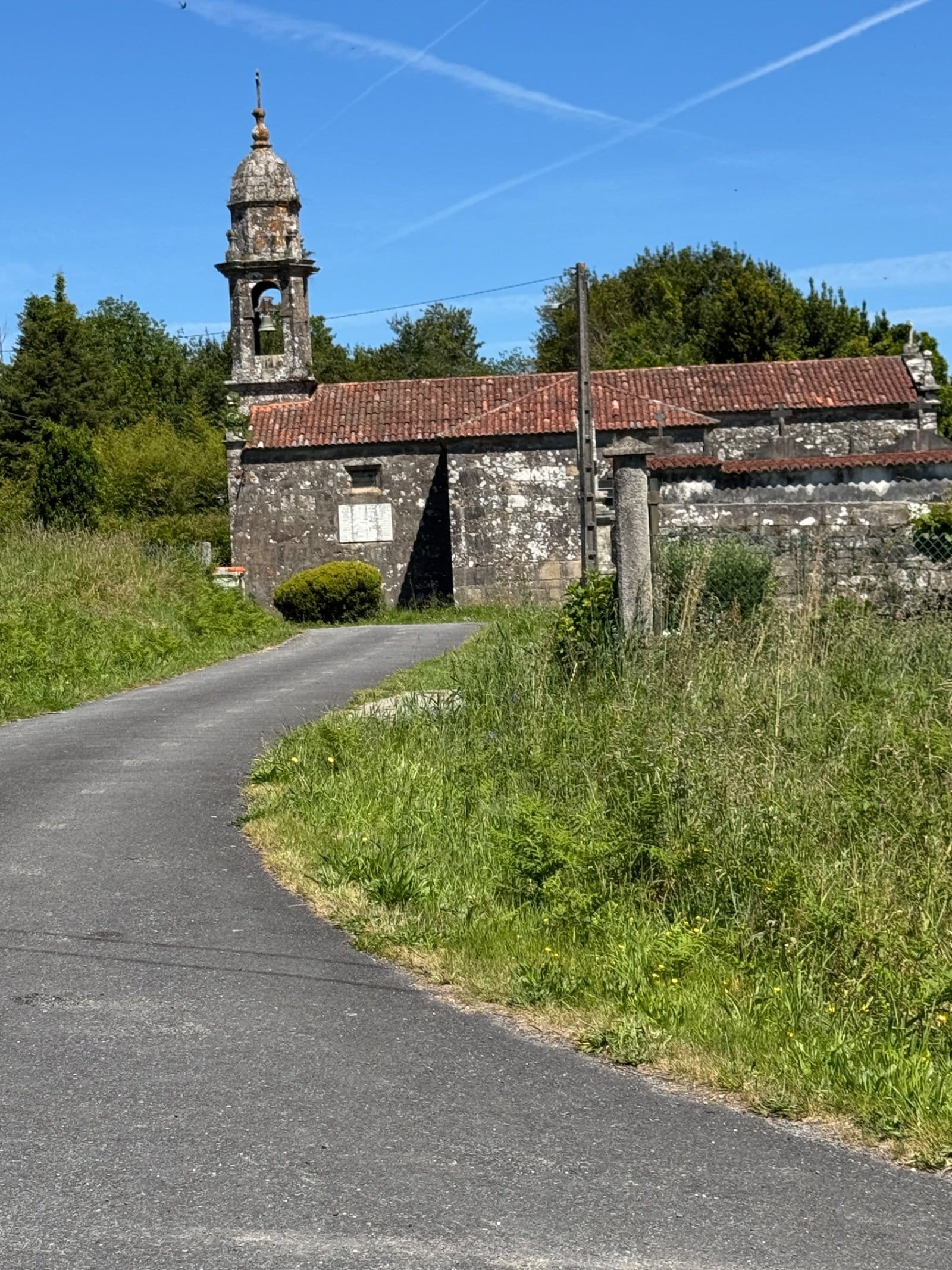 Traditional Galician stone church with bell tower