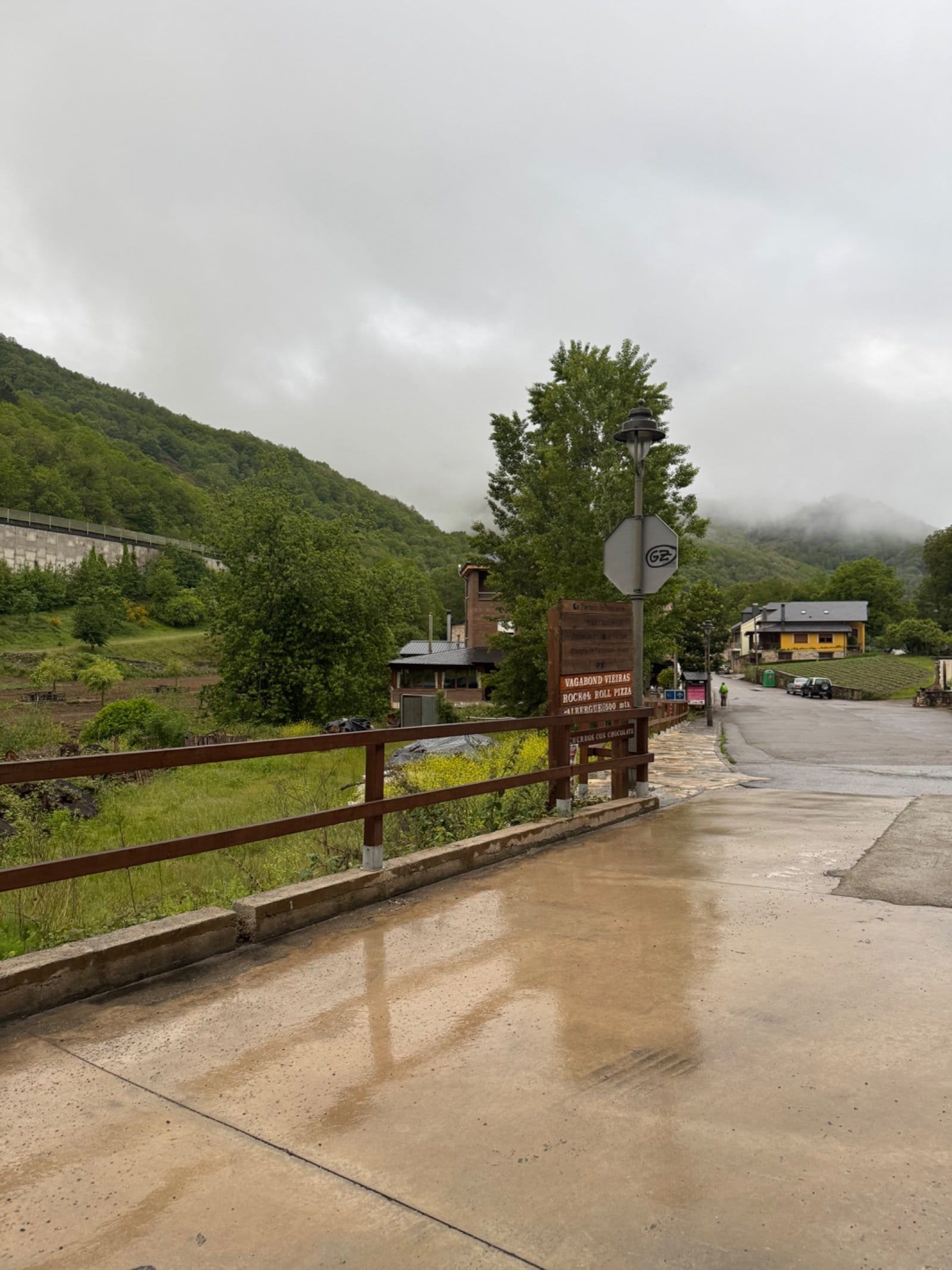 Wet village street in mountainous terrain