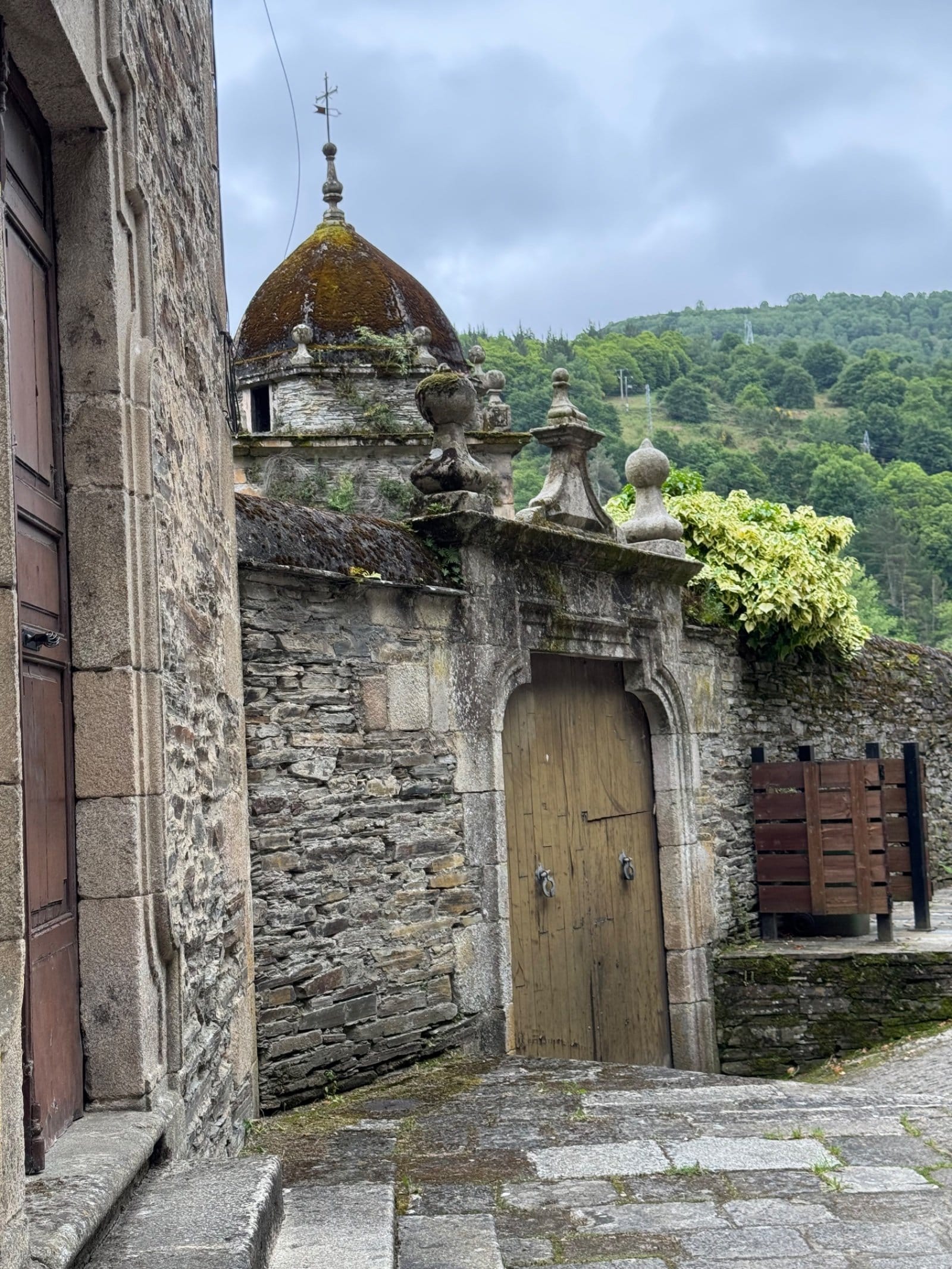Historic monastery gate with ornate stonework in Samos