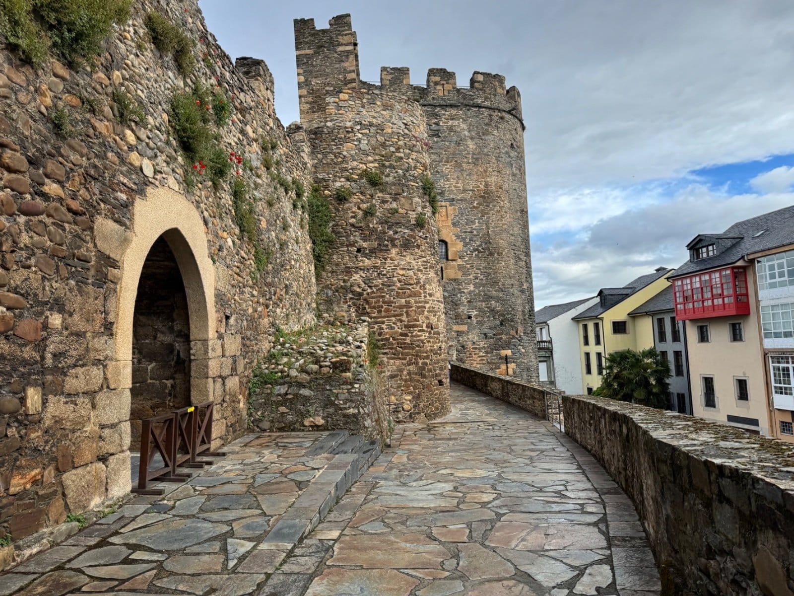 Castle ramparts overlooking Ponferrada's colorful buildings