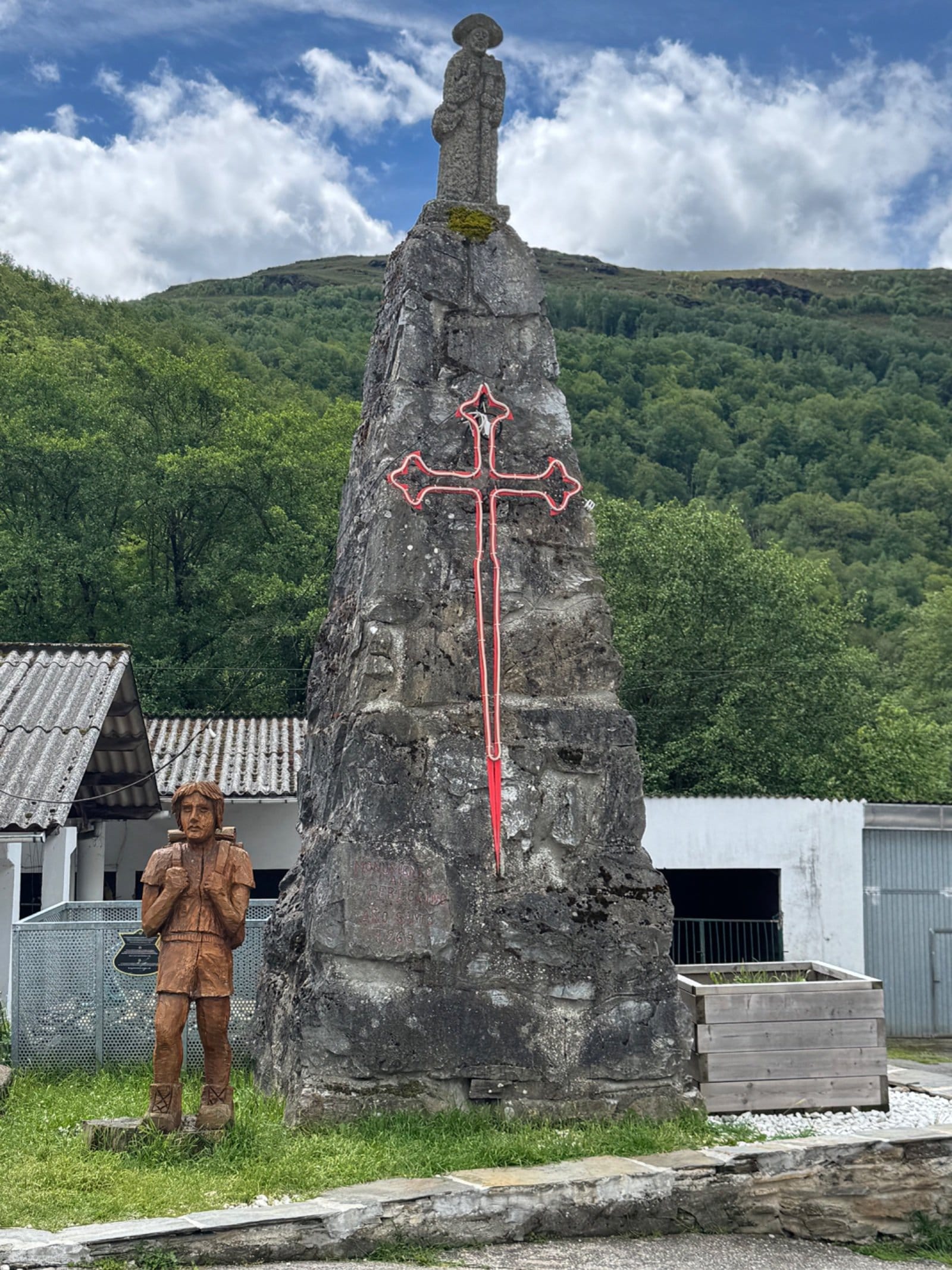 Stone pilgrim cross monument in Triacastela