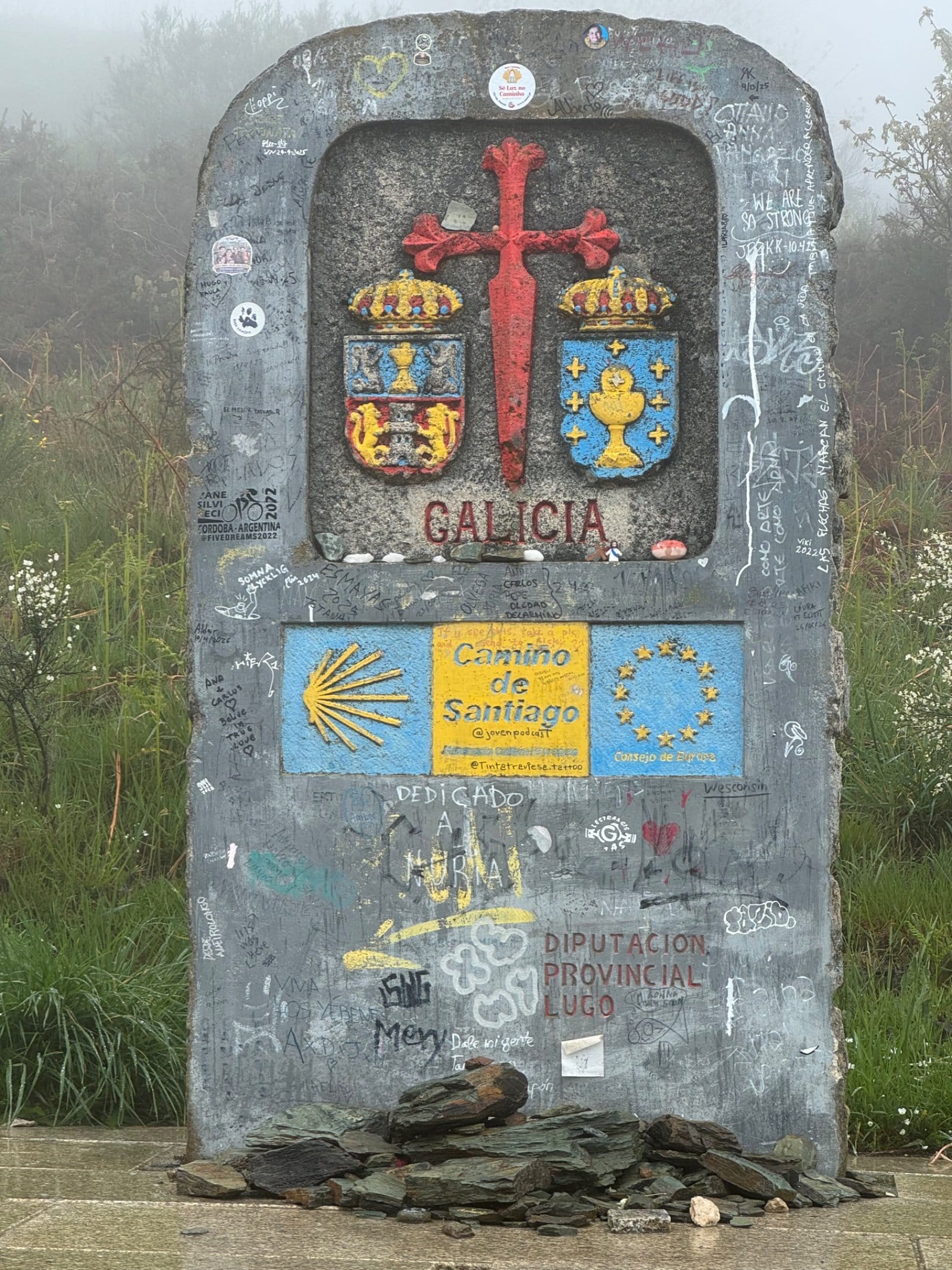 Galicia province entrance marker with pilgrim graffiti